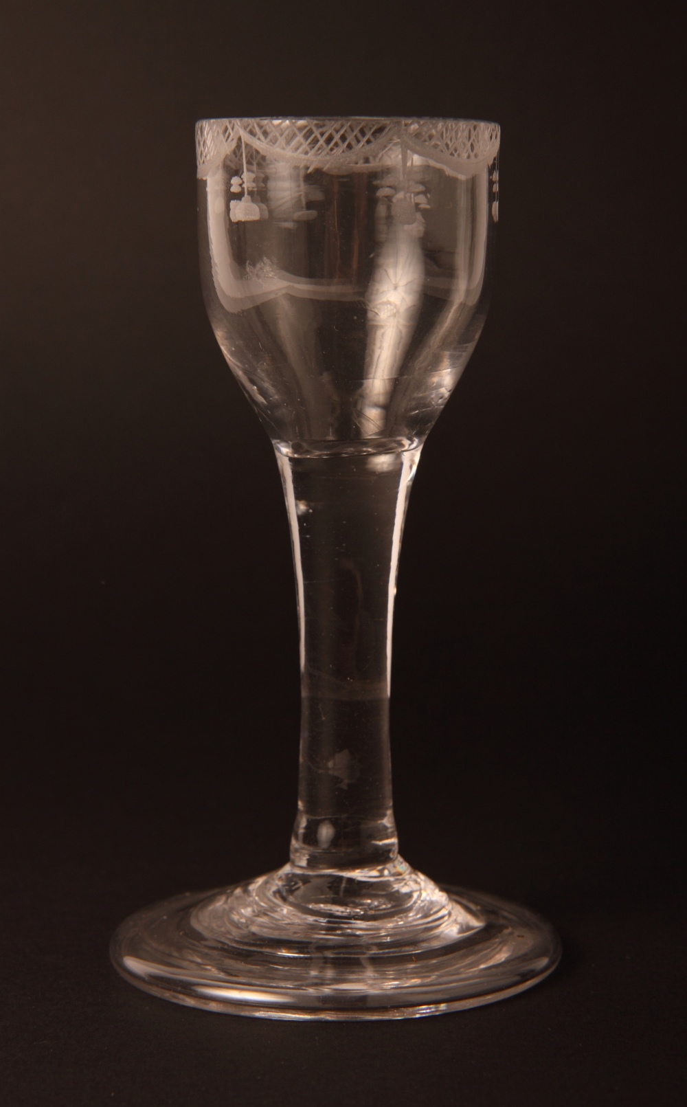 An 18th Century wheel engraved cordial glass with folded foot and five other glasses