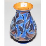 A Burleigh ware relief decorated vase with copper lustre leaves and squirrel design, 9 1/2" high