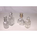 A Georgian cut glass three ring necked decanter, a silver mounted decanter and two spirit decanters