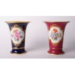 A trumpet-shaped vase decorated oval floral reserve on a dark blue ground, 6 1/2" high, and a
