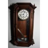 A walnut cased wall clock with compensating pendulum striking and chiming movement