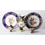 A pair of 19th Century blue and gilt decorated cabinet plates with hand-painted floral centres, a