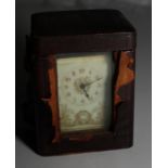 A brass framed carriage clock with gilt decorated cream dial and travelling case