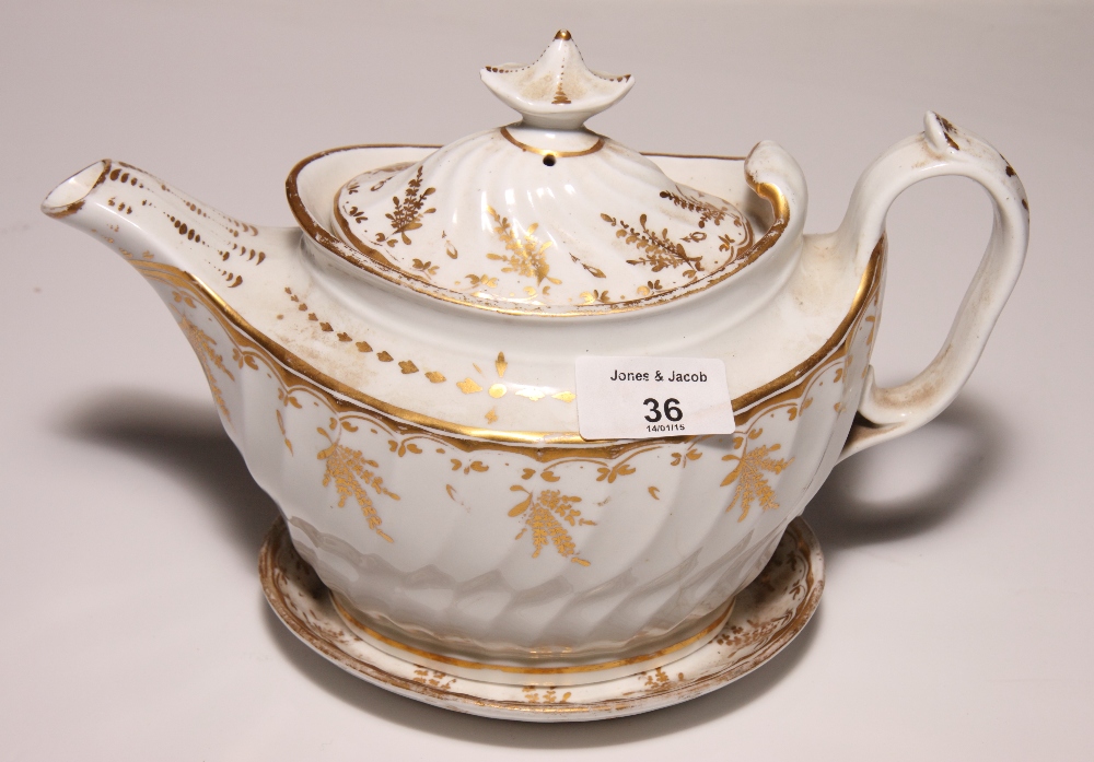 A 19th Century bone china gilt decorated teapot on stand