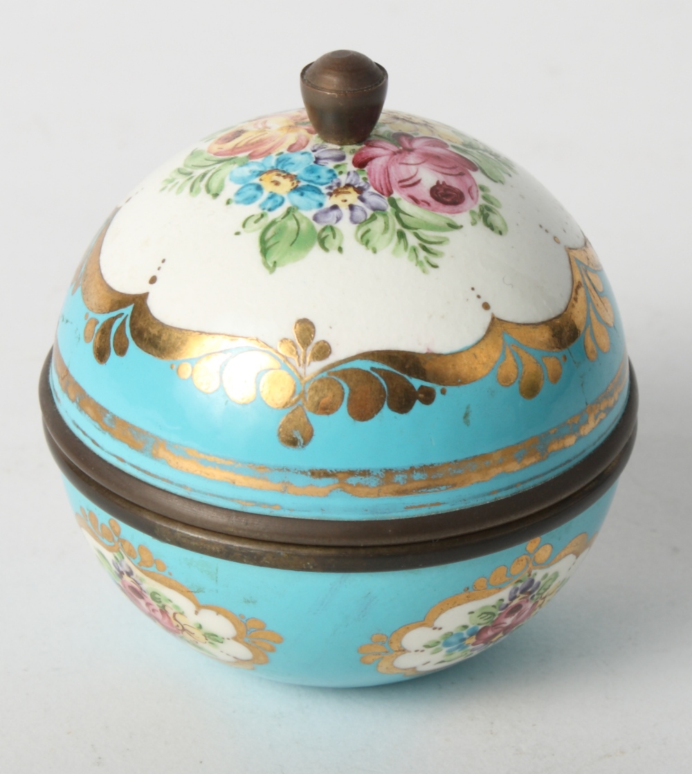 A Sèvres style spherical box and cover with enamel floral panels on a blue ground