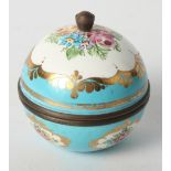 A Sèvres style spherical box and cover with enamel floral panels on a blue ground