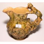 A 19th Century relief moulded jug with figure handle, 10" high