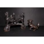 An Eastern triangular wooden stand carved three winged animals and an oriental bronze censer in