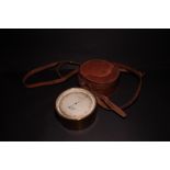 A WWI brass cased travelling barometer by J Hicks, in leather travelling case