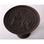 A bronze tazza with relief figural decoration, 6" high