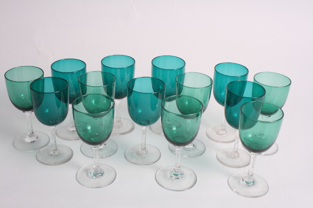 Fourteen wine glasses with green glass bowls on clear stems