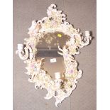 A 19th Century Sitzendorf china girandole with flower and cherub encrusted frame fitted three candle