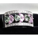 A 14ct white gold ring with rectangular pierced floral panel set pink and green sapphires within a