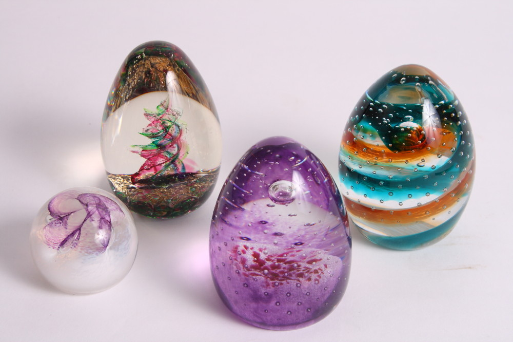 Three Caithness glass paperweights, "Tropical Rain", "Rain Dance" and "Pixie", and a Selkirk glass