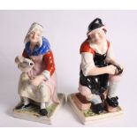 A pair of continental ceramic figures of seated peasants, 13" high