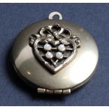 A yellow gold hinged locket with heart-shaped motif mounted four seed pearls