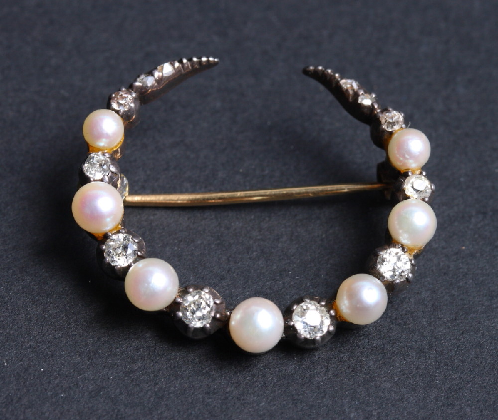 A Victorian gold, diamond and pearl set crescent brooch