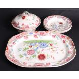 A set of four Spode soup plates with transfer decoration of oriental flowers, a matching meat