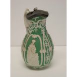 A 19th Century relief moulded jug with figures on a green ground depicting commerce, music,