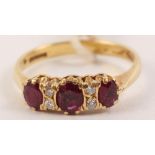 An 18ct gold dress ring set three rubies and diamonds