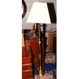 A brass standard lamp on spiral reed column and circular base and a mahogany canterbury