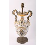 A faïence vase with serpent handles, fitted as a table lamp, on gilt metal base