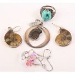 A pair of silver earrings, each set with a fossilised ammonite, a similar pendant, a pair of