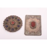 A Jordanian "silver" brooch set hardstones and a similar panel