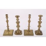 A pair of early Georgian design pillar candlesticks, on square bases, 10 1/2" high, and a pair of