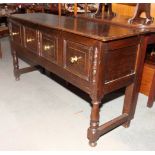 An oak dresser base of 17th Century design, fitted two deep drawers, on turned and stretchered