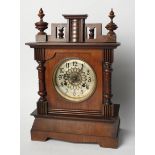 A mahogany mantel clock of architectural form with silvered dial