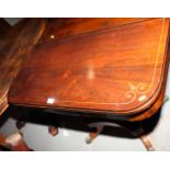A William IV rosewood and brass line inlaid fold-over top card table, on quadraform castored base,