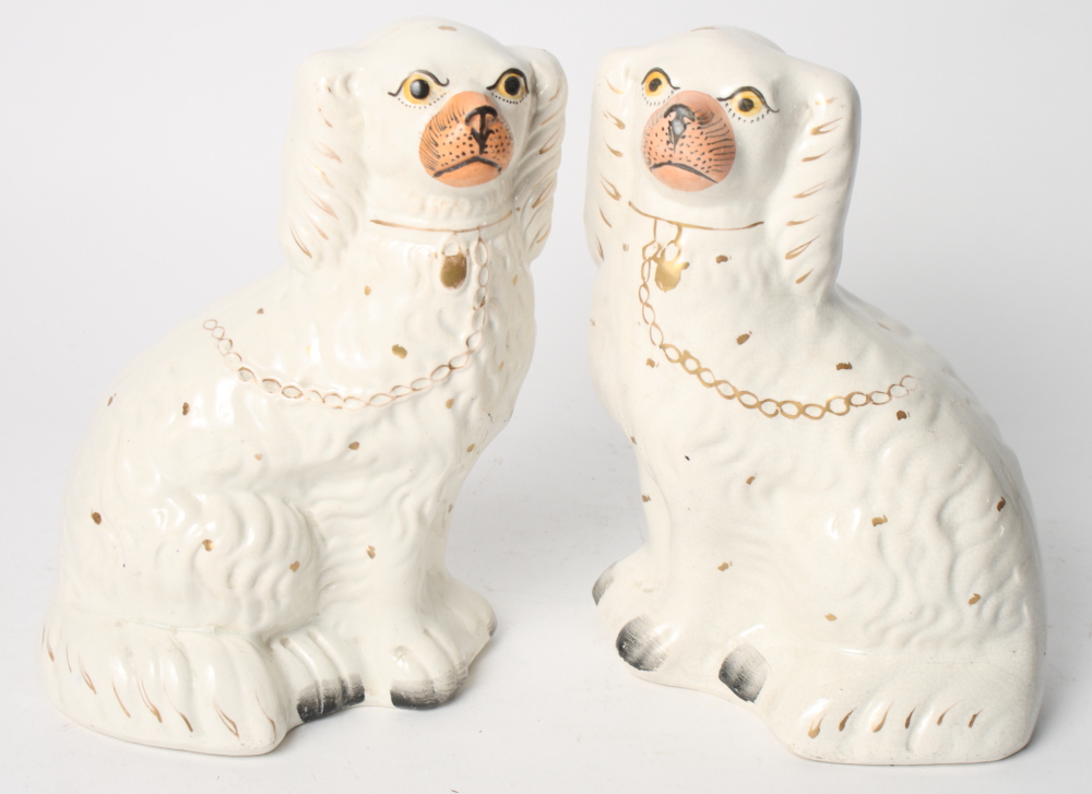 A pair of Staffordshire dogs, 9" high, and a pair of oak candlesticks with scroll carved square