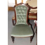 A late Victorian nursing chair with stained as walnut frame, upholstered in a green velour