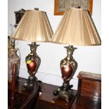 A pair of bronzed and silvered two-handled table lamps with pleated shades