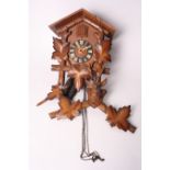 A Black Forest cuckoo clock with carved stag's head finial