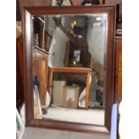 An oak framed rectangular wall mirror with bevelled plate, 45" x 32"