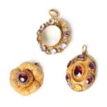 A 19th Century yellow metal and amethyst locket, a 19th Century pendant set garnet cabochon and a