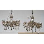 A pair of five-branch glass chandeliers hung facetted glass drops