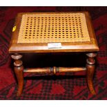 A 19th Century fruitwood miniature cane top stool, on turned splay supports