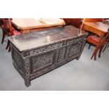 A 17th Century oak blanket box with carved three panel front and old iron lock plate, 55" wide