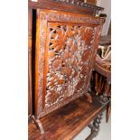 A wooden firescreen carved and pierced floral designs, 25" wide, and a mahogany rectangular