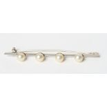 A white metal bar brooch mounted four pearls