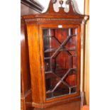 A Georgian mahogany line inlaid wall mounted corner cupboard with scroll pediment and astragal