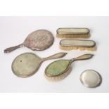 A silver and shagreen mounted four-piece dressing table set (a/f) and a silver backed hand mirror