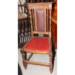 An Arts & Crafts oak single chair with red nailed leatherette back and seat panels