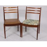 A set of seven G Plan rail back dining chairs with brown leather seats
