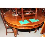 A 19th Century mahogany D-end extending dining table with two extra leaves, on turned and fluted