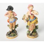 A pair of 19th Century Derby china figures in 18th Century dress holding flowers, 7" high (some