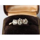 An 18ct gold three stone old cut diamond ring